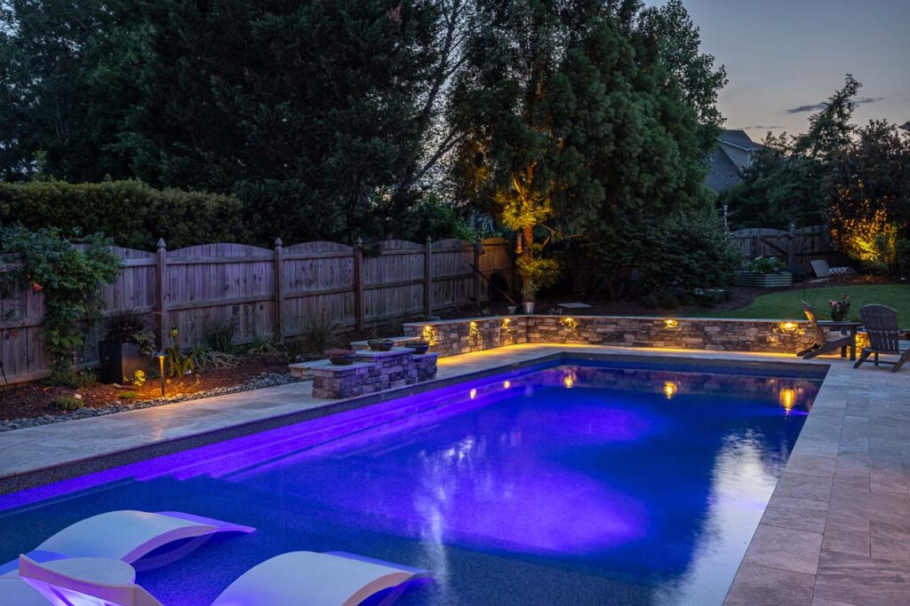 Night view of Dominion pool showcasing low-voltage lighting.