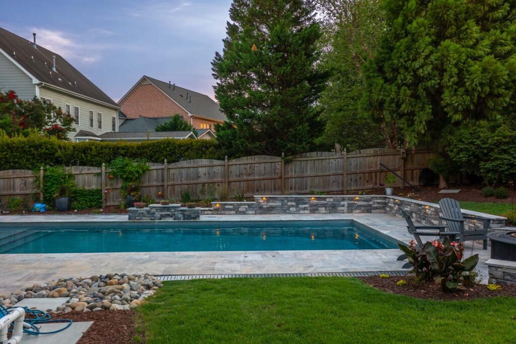 Wide shot view of Dominion pool with fire place on the right corner.