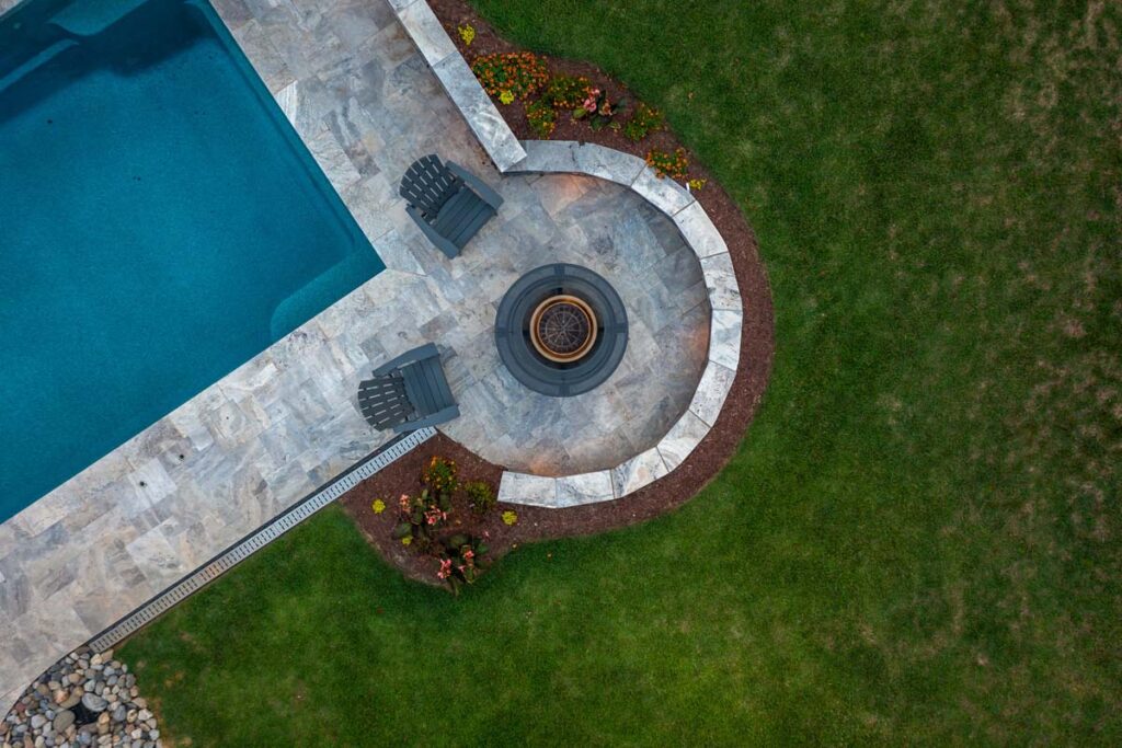 Aerial view of Dominion fire pit positioned at the corner of the pool.