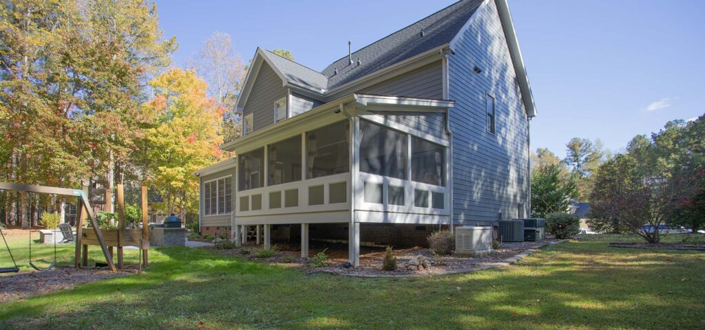 Corner view of Northlake project featuring screen deck and a swing set and patio area on the left.
